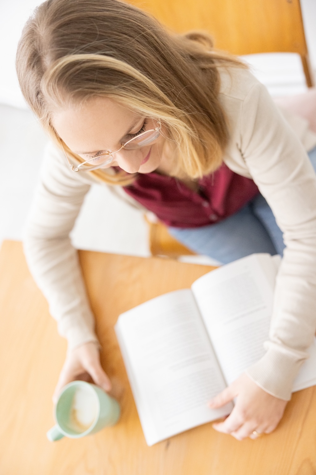Dr. med. Vera Vogel reading a book in a peaceful setting, symbolizing her multicultural background and love for languages spanning from Sardinia to Germany to Latin America